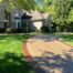 New stained, exposed aggregate concrete driveway with a stained border in Carmel, Indiana.