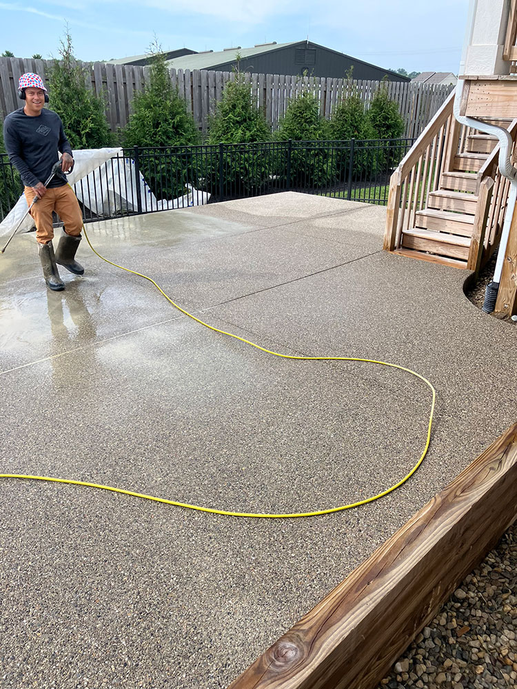 New exposed aggregate concrete backyard patio in Westfield, Indiana.