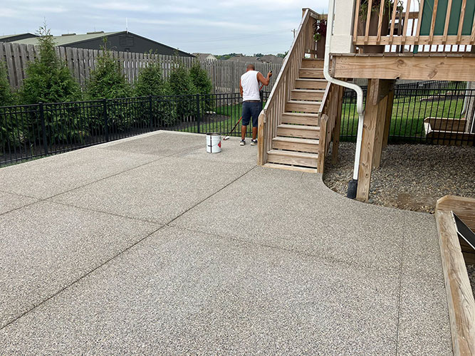 New exposed aggregate concrete backyard patio in Westfield, Indiana.